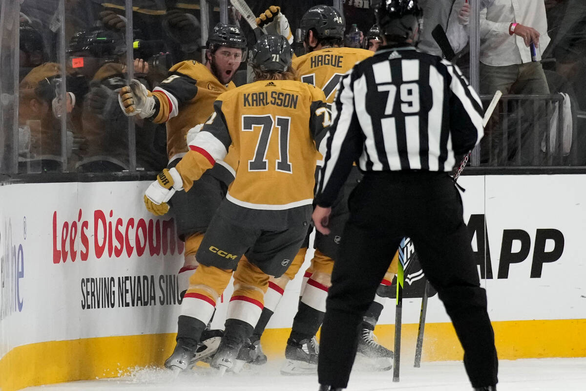 Vegas Golden Knights center Paul Cotter, left, celebrates after scoring against the Philadelphi ...