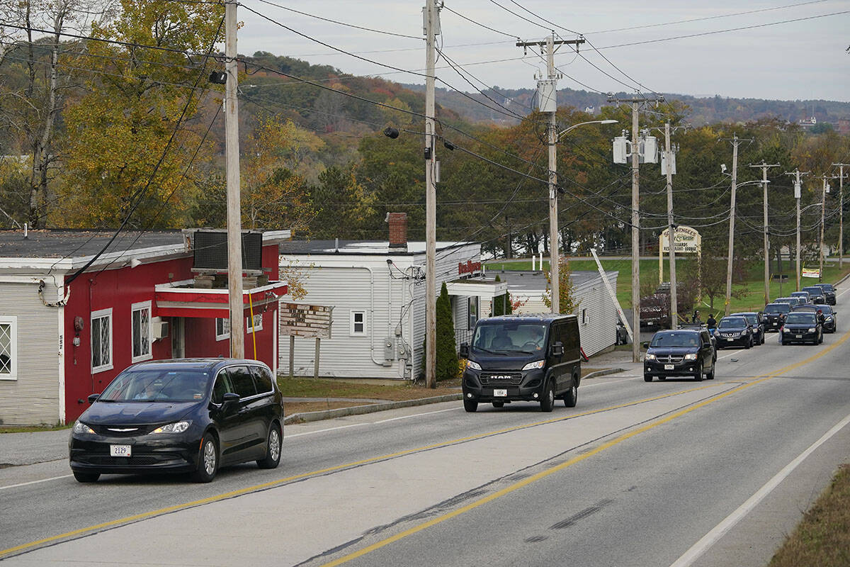 Three vehicles transport bodies from Schemengees Bar and Grille, Thursday, Oct. 26, 2023, in Le ...