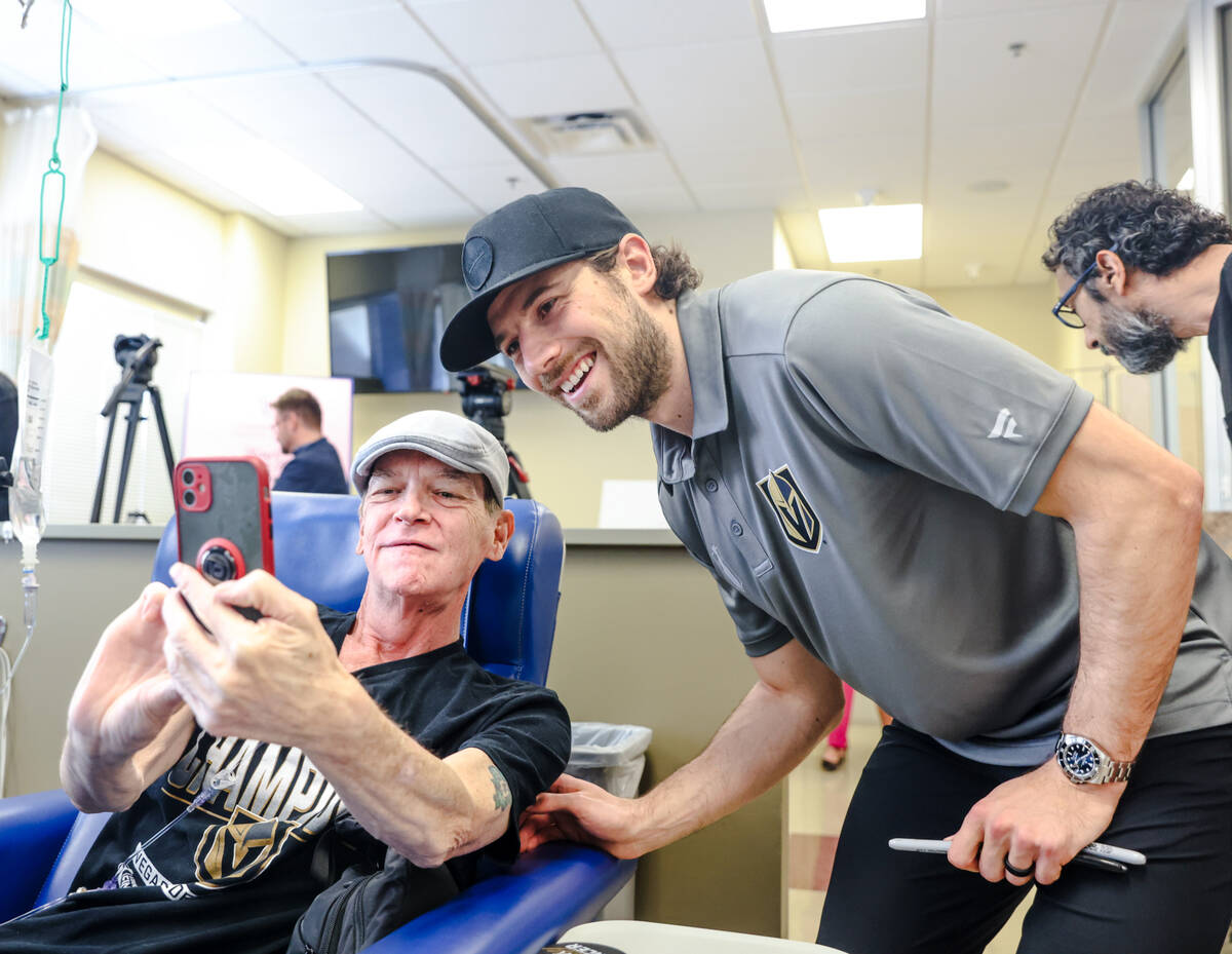 Shea Theodore, defenseman for the Golden Knights, takes a selfie with patient Shawn Tracy at th ...