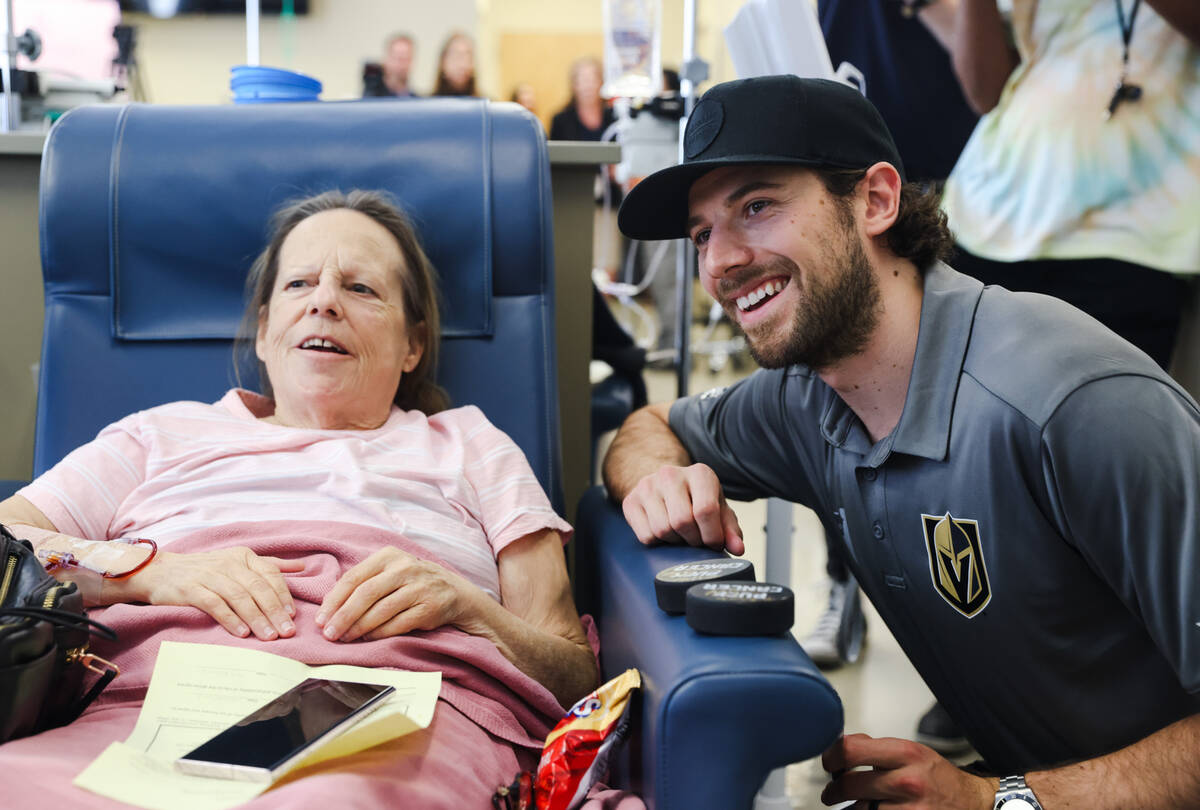Shea Theodore, defenseman for the Golden Knights, smiles for a photo with patient Roberta Willi ...