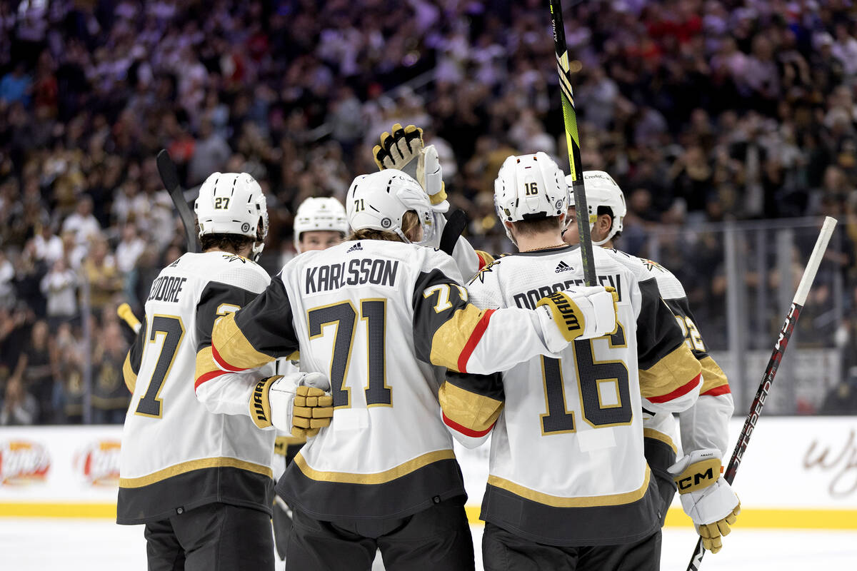 Golden Knights center William Karlsson (71) celebrates with his team after scoring during the f ...