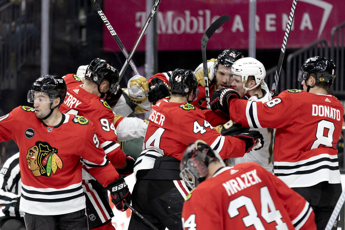 The Blackhawks and the Golden Knights fight during the first period of an NHL hockey game at T- ...
