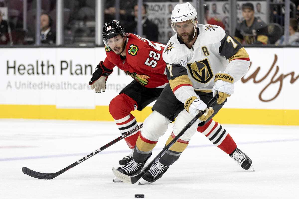 Golden Knights defenseman Alex Pietrangelo (7) controls the puck against Blackhawks center Rees ...