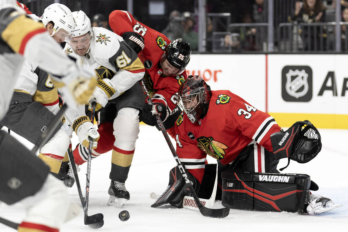 Golden Knights right wing Mark Stone (61) battles at the net with Blackhawks defenseman Jarred ...