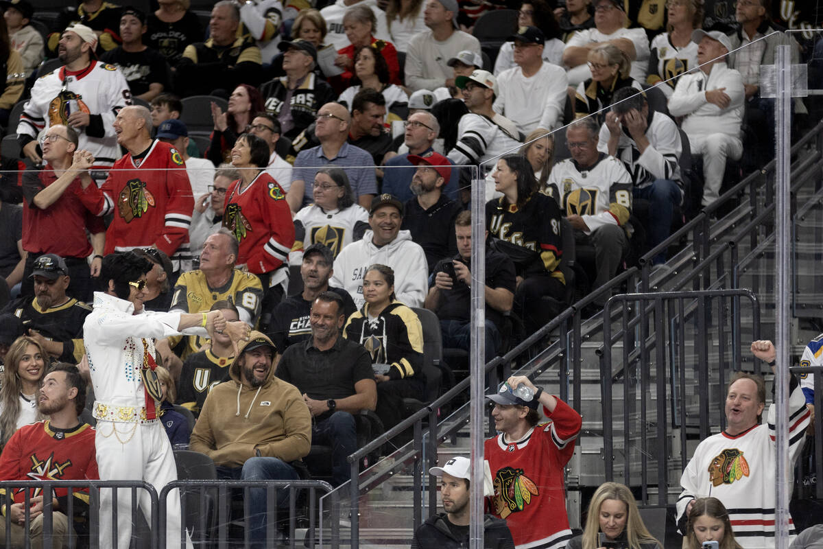 A Golden Knights fan, dressed as Elvis, heckles Blackhawks fans during the third period of an N ...