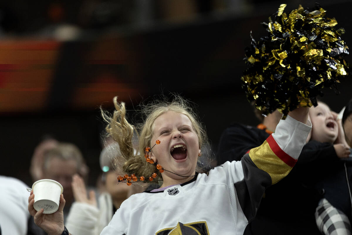 A young Golden Knights fan goes wild for her team during the third period of an NHL hockey game ...