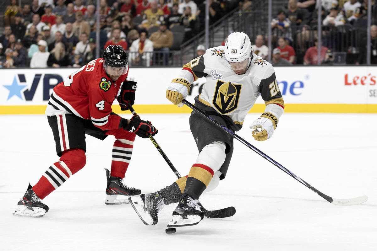 Golden Knights center Chandler Stephenson (20) is tripped by Blackhawks defenseman Seth Jones ( ...