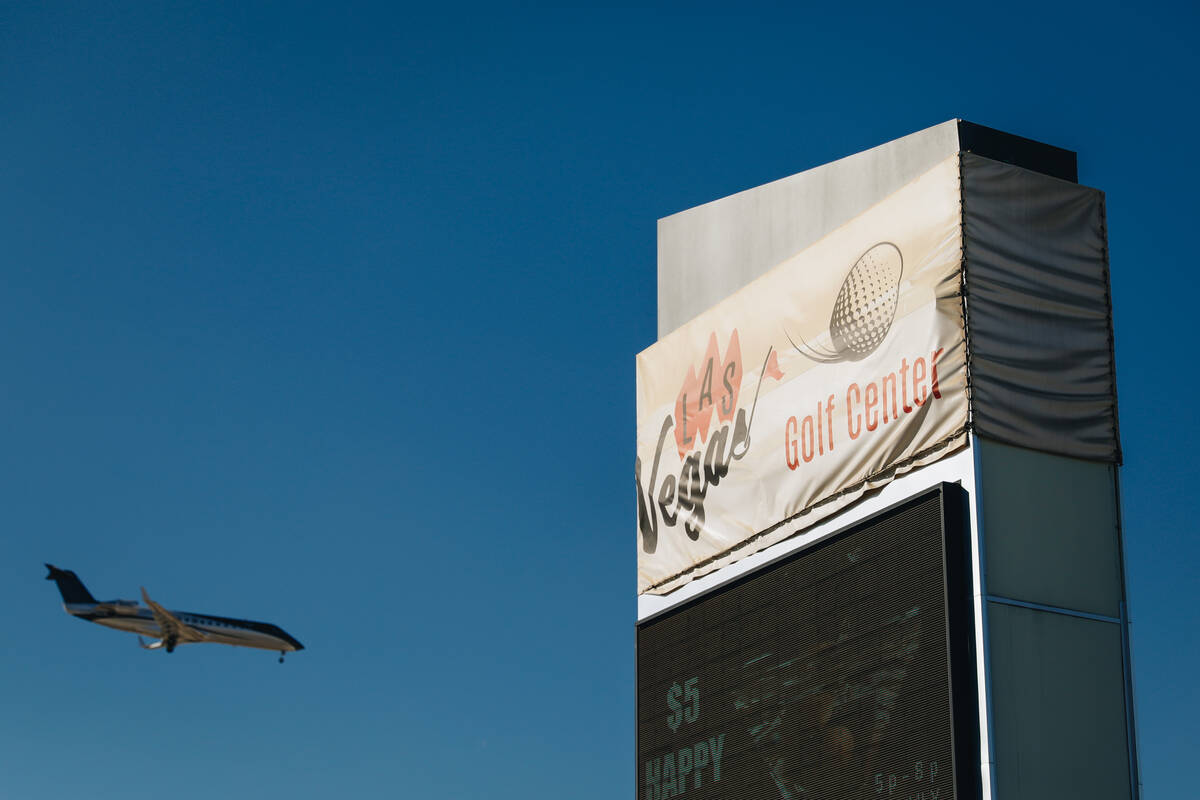 An airplane flies by the Las Vegas Golf Club sign at Las Vegas Golf Club on Saturday, Oct. 28, ...