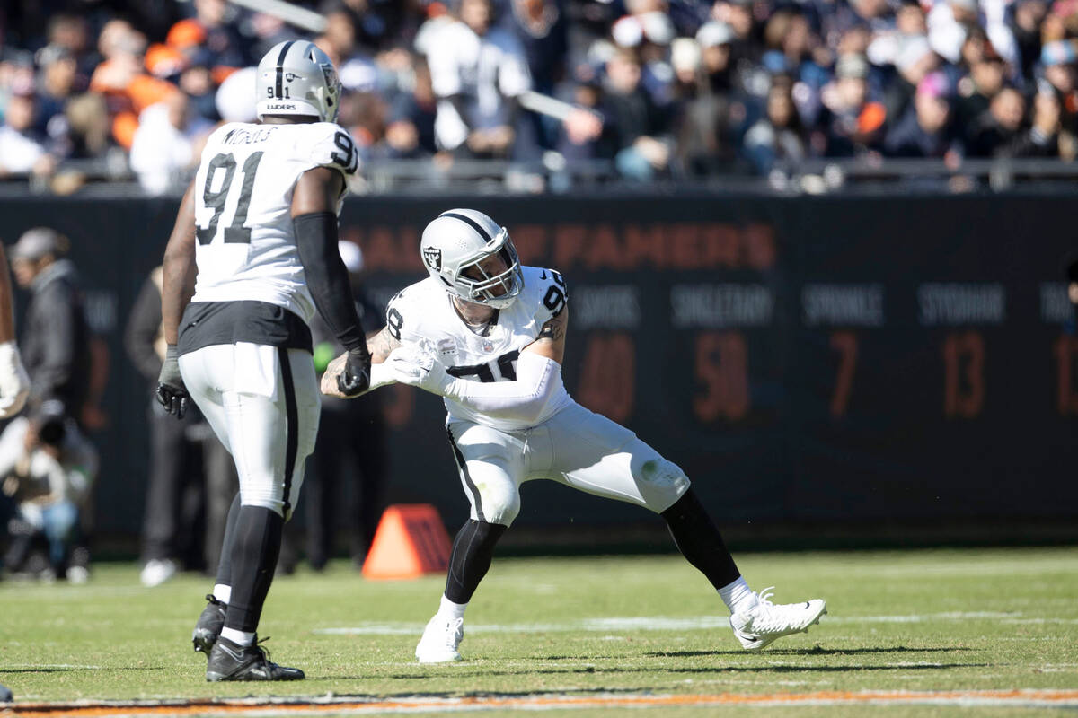 Raiders defensive end Maxx Crosby (98) celebrates his sack of Chicago Bears quarterback Tyson B ...