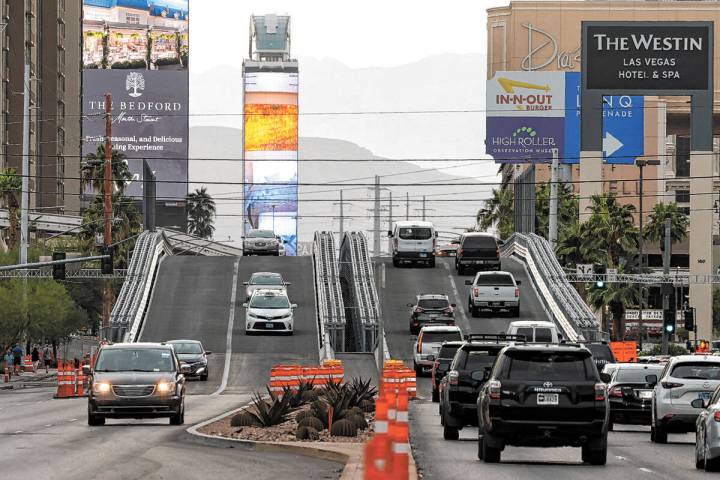 Motorists navigate over the completed temporary Las Vegas Grand Prix Flamingo bridge over Koval ...