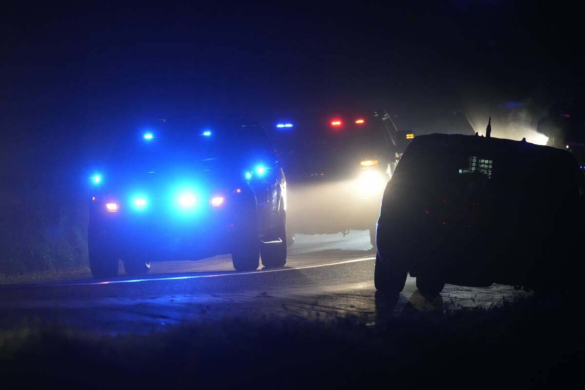 Law enforcement vehicles depart a scene at a property on Meadow Road, in Bowdoin, Maine, Thursd ...