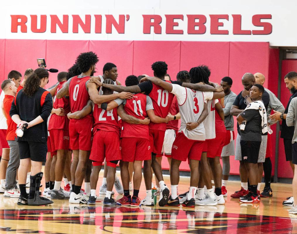 UNLV's basketball players gathered to listen to their coach Kevin Kruger after team practice, o ...