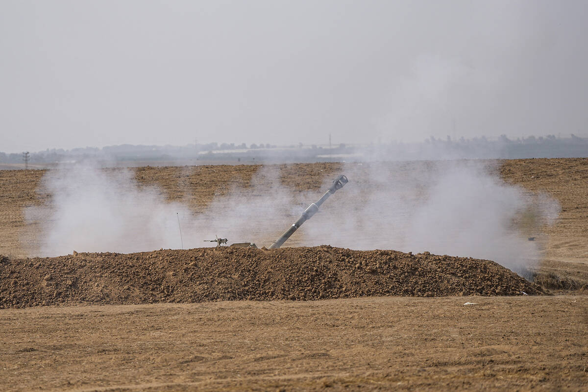 An Israeli mobile artillery unit fired a shell from southern Israel towards the Gaza Strip, in ...