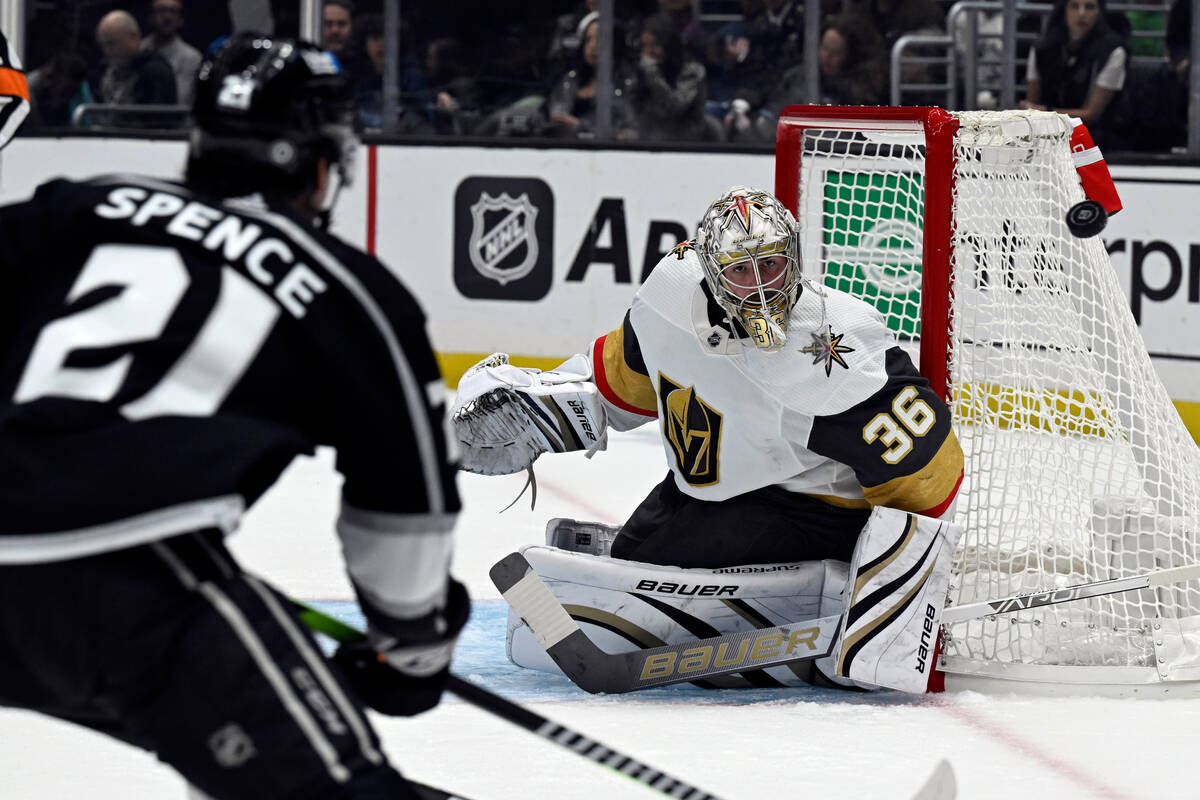 Vegas Golden Knights goaltender Logan Thompson (36) deflects a shot by Los Angeles Kings defens ...