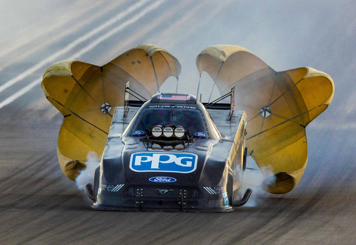 Bob Tasca III deploys his parachute during a Funny Car qualifying session in the NHRA Nevada Na ...