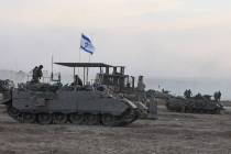 Israeli armored vehicles and bulldozers gather near the border with Gaza before entering the Pa ...
