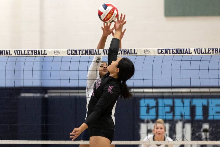 Centennial middle blocker Jada Thomas-Swinson (16) tangles above the net with Faith Lutheran se ...