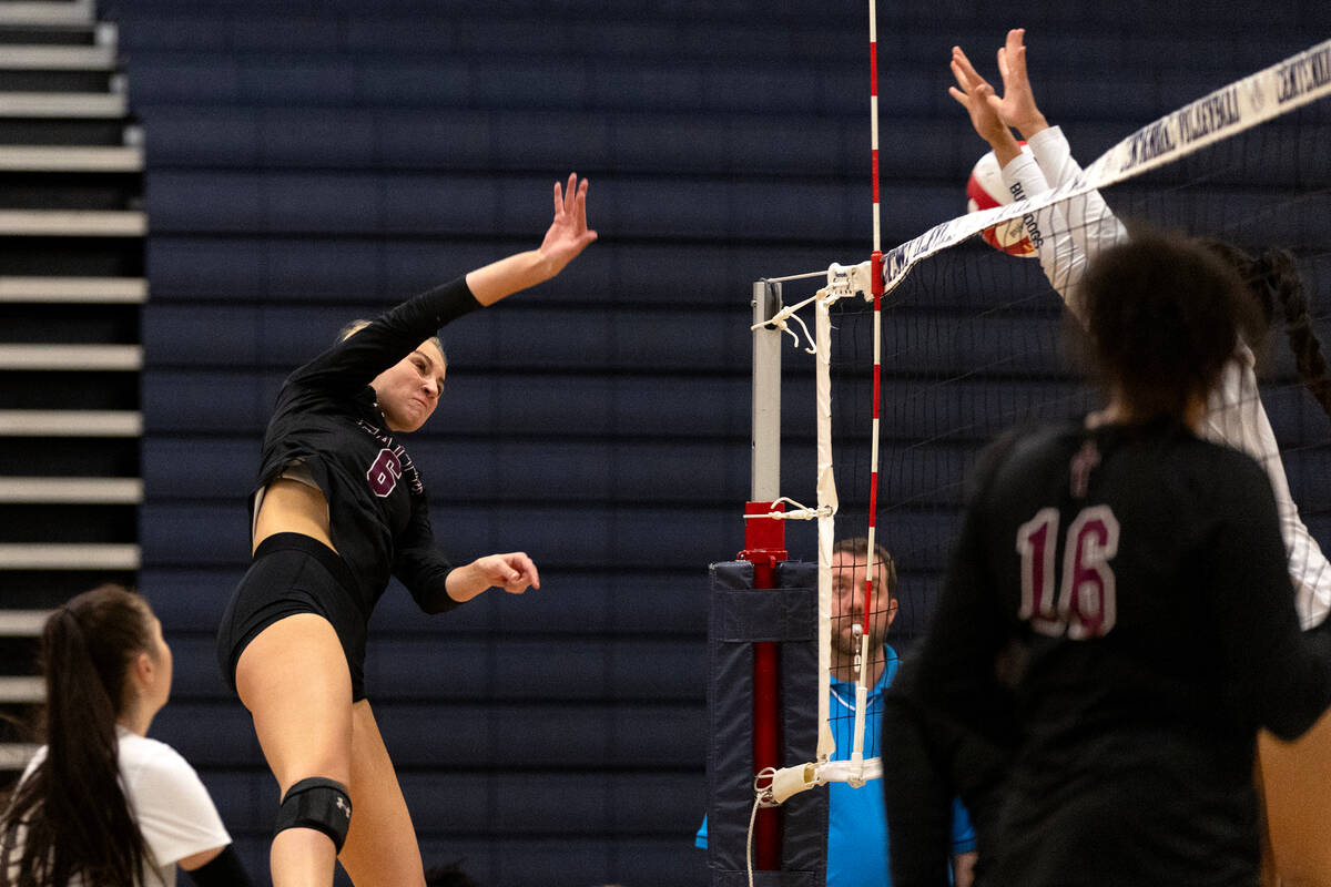 Faith Lutheran outside hitter Bianca Richardson (6) spikes the ball past Centennial during a Cl ...