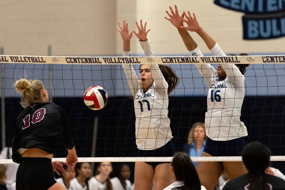 Centennial outside hitter Aleyson Ross (17) and middle blocker Jada Thomas-Swinson (16) kill a ...