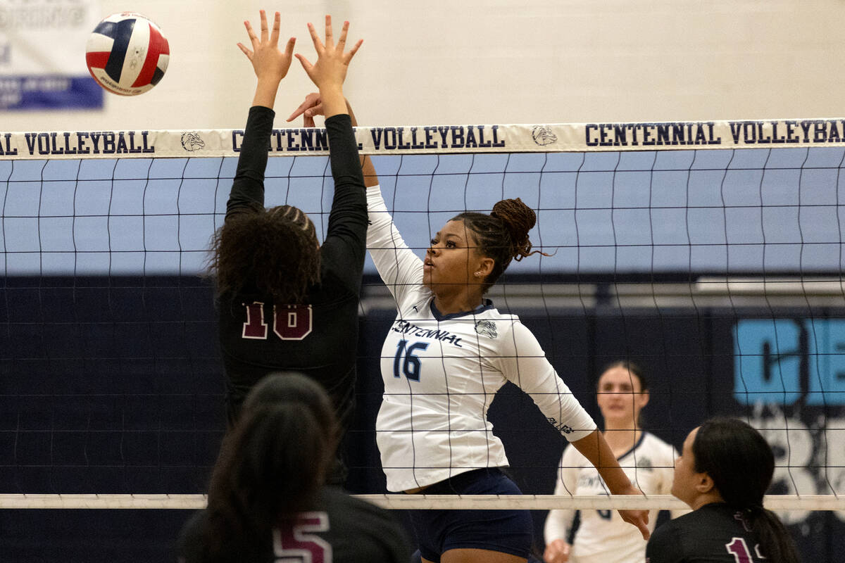 Faith Lutheran middle blocker Andrea Romero-Agosto (16) tips the ball past Faith Lutheran middl ...