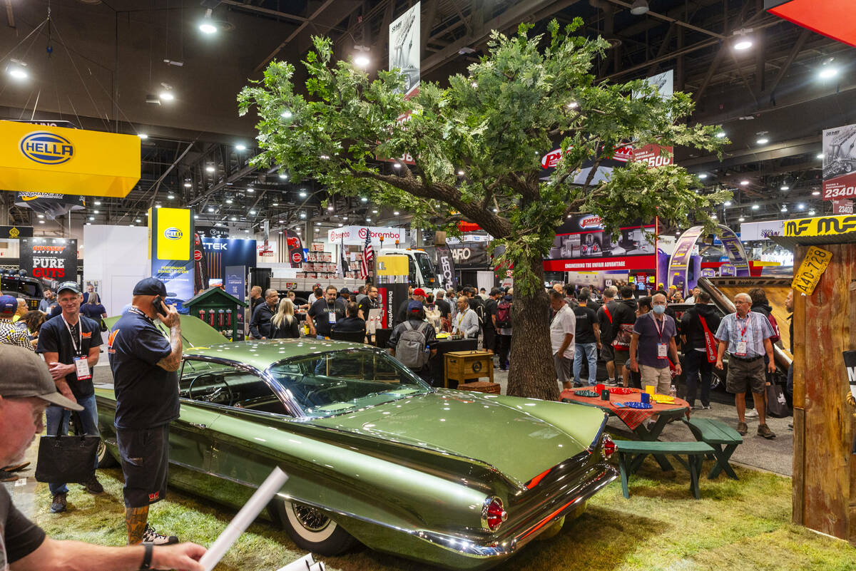 A classic car dried by the Absorber glistens under a fake tree during the first day of SEMA at ...