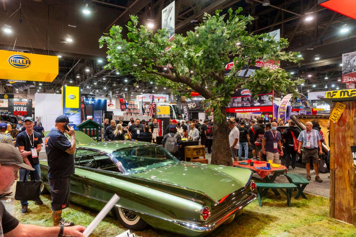 A classic car dried by the Absorber glistens under a fake tree during the first day of SEMA at ...