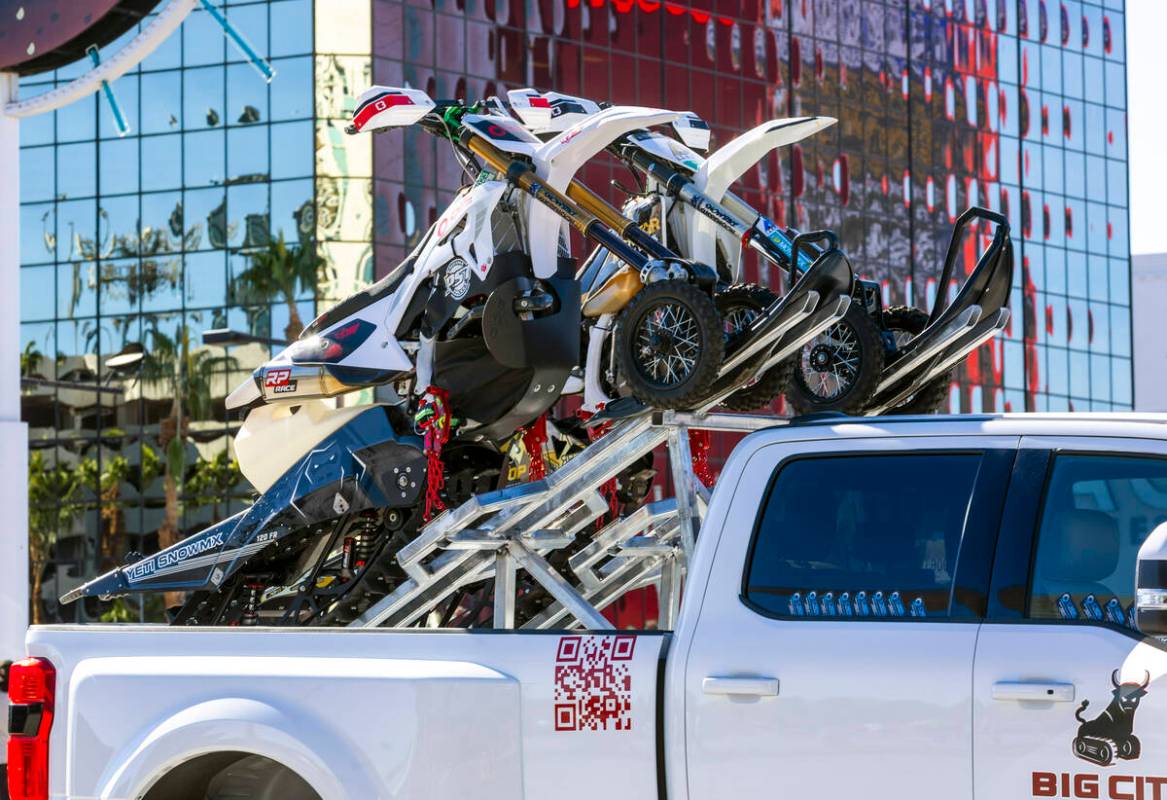 Snowmobiles are attached to a custom rack outside during the first day of SEMA at the Las Vegas ...