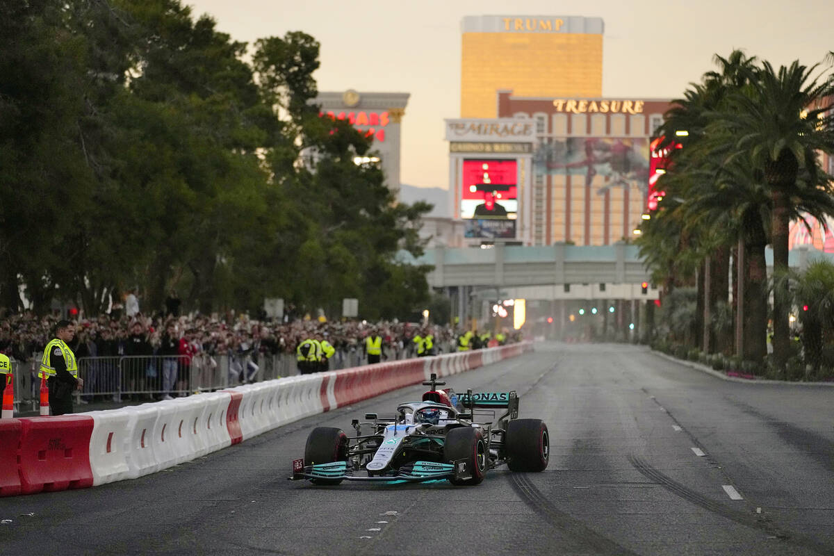 FILE - George Russell drives during a demonstration along the Las Vegas Strip at a launch party ...