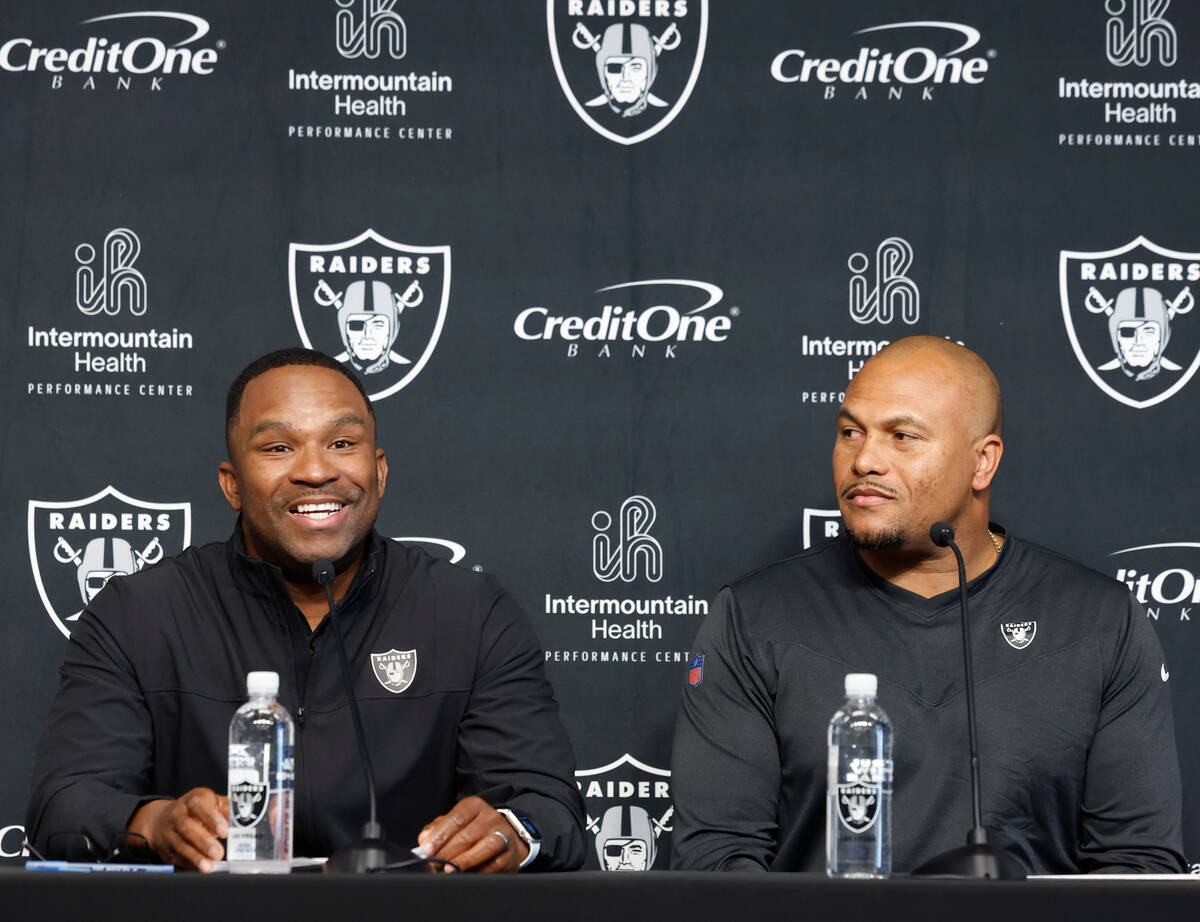 Champ Kelly, left, Raiders interim general manager, speaks during the press conference as Anton ...