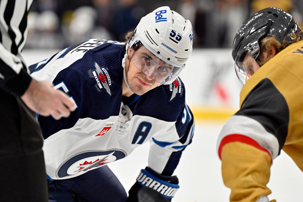 Winnipeg Jets center Mark Scheifele (55) watches the puck before a face off against Vegas Golde ...