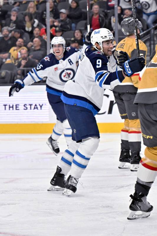 Winnipeg Jets left wing Alex Iafallo (9) and center Mark Scheifele (55) celebrate Iafallo's goa ...