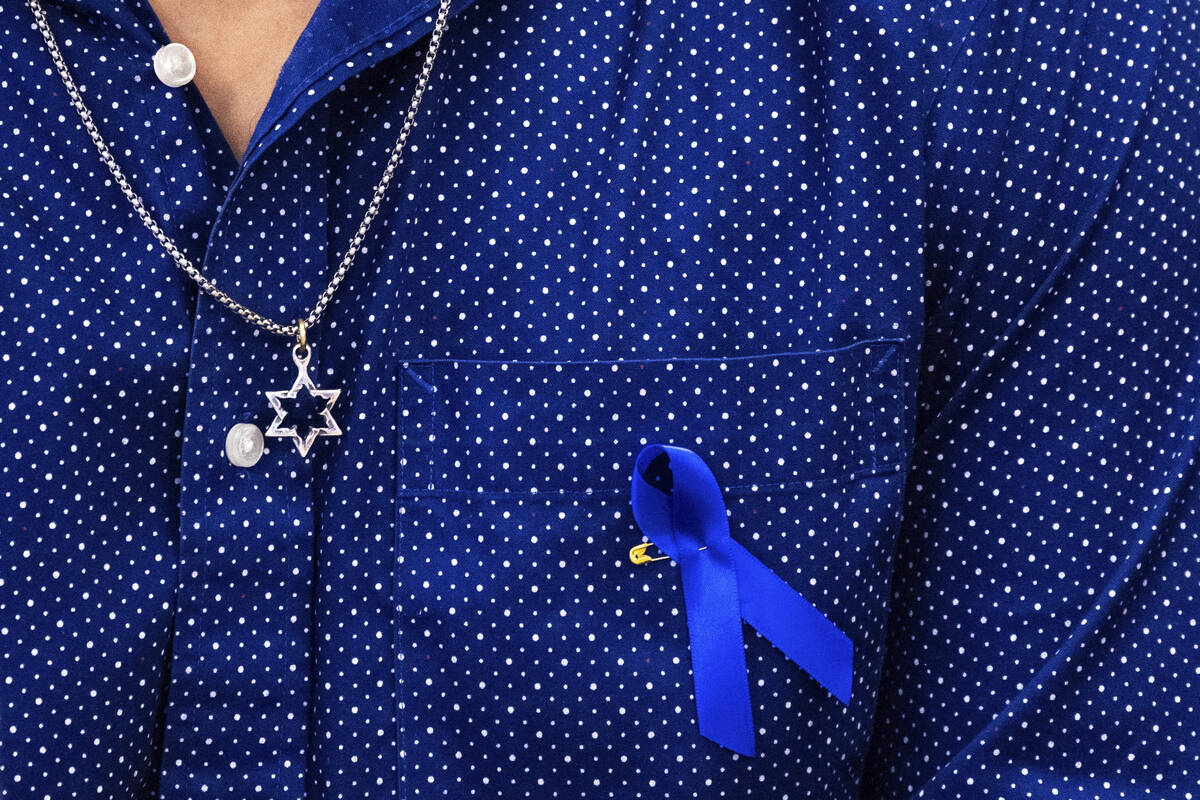 Samuel Winkler wears a Star of David necklace and a blue ribbon during a visit by Education Sec ...