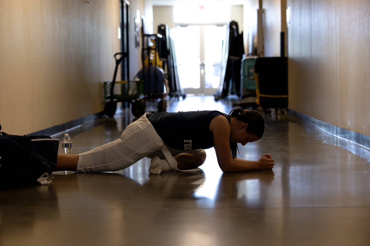 Kicker Gracie Rhodes stretches outside the boys locker room while her teammates suit up for a C ...