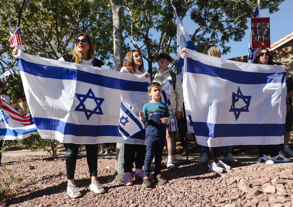 Pro-Israel demonstrators gather in response to graffiti written on a wall in a neighborhood the ...