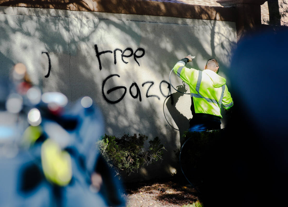 A city worker sprays over graffiti written the night before that said “Death 2 Jews&#x20 ...