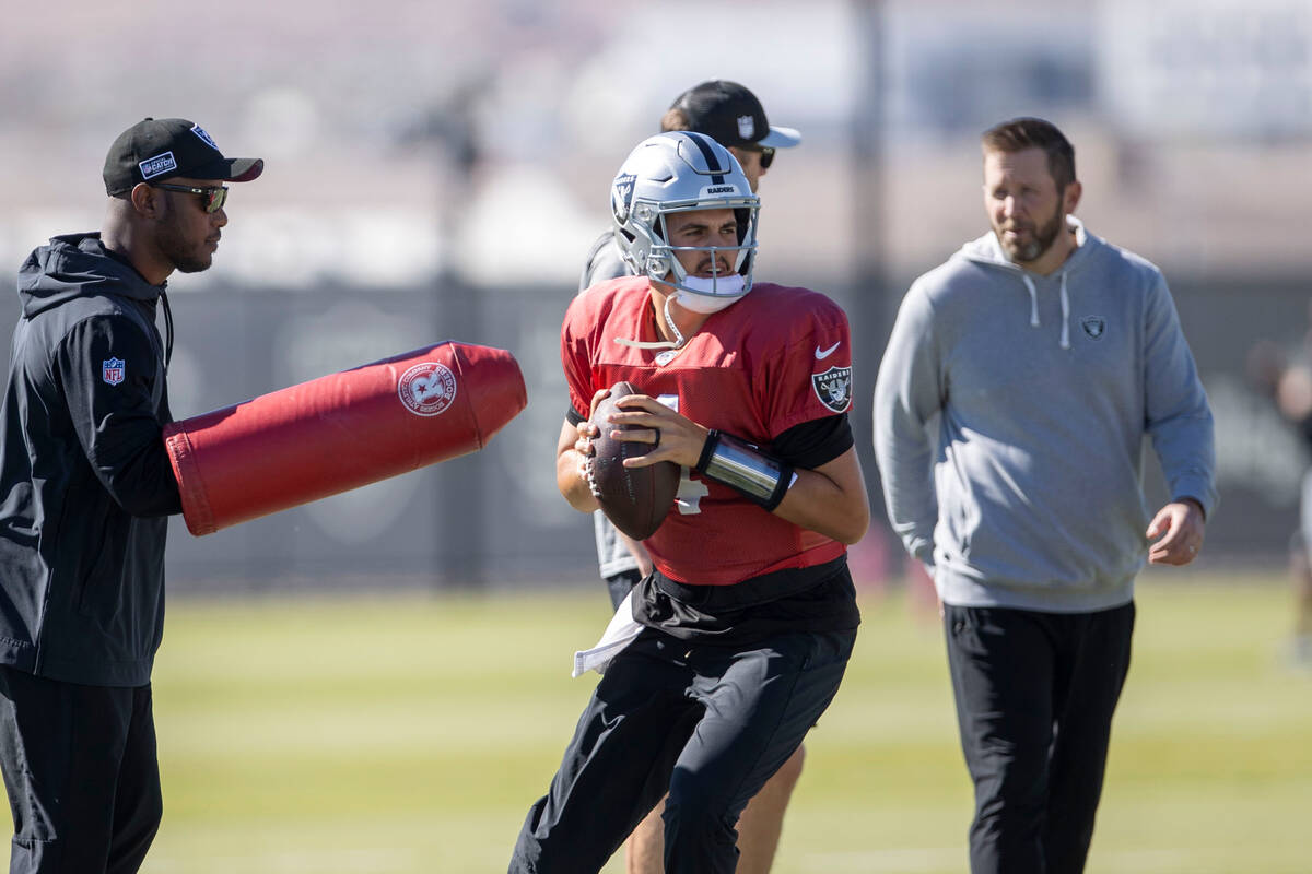 Raiders quarterback Aidan O'Connell (4) gets ready to throw during practice at the Intermountai ...