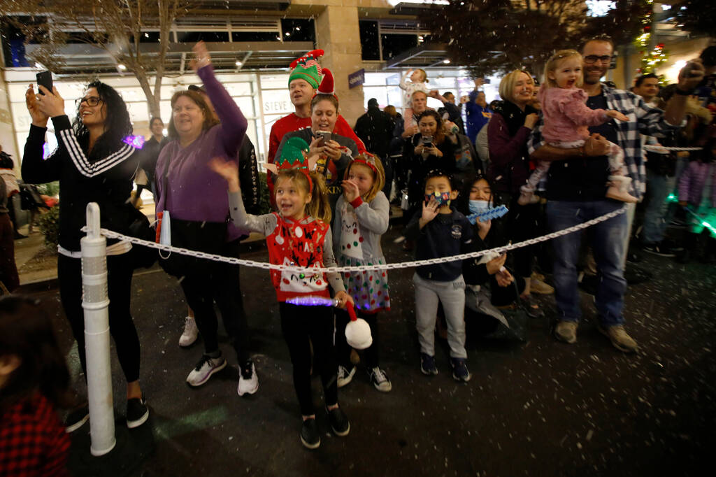 People cheer during the holiday parade at Downtown Summerlin on Friday, Dec. 3, 2021, in Las Ve ...