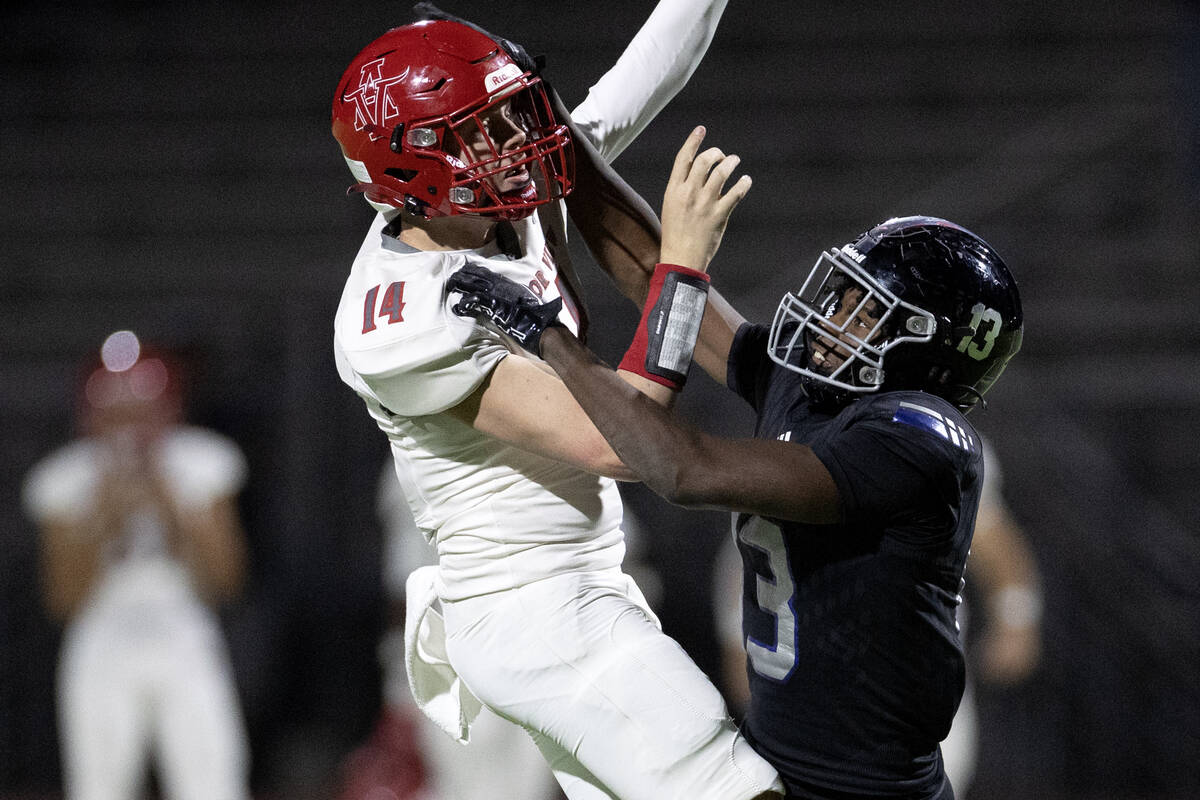 Arbor View quarterback Alonzo Balderrama (14) attempts to throw while Desert Pines linebacker S ...