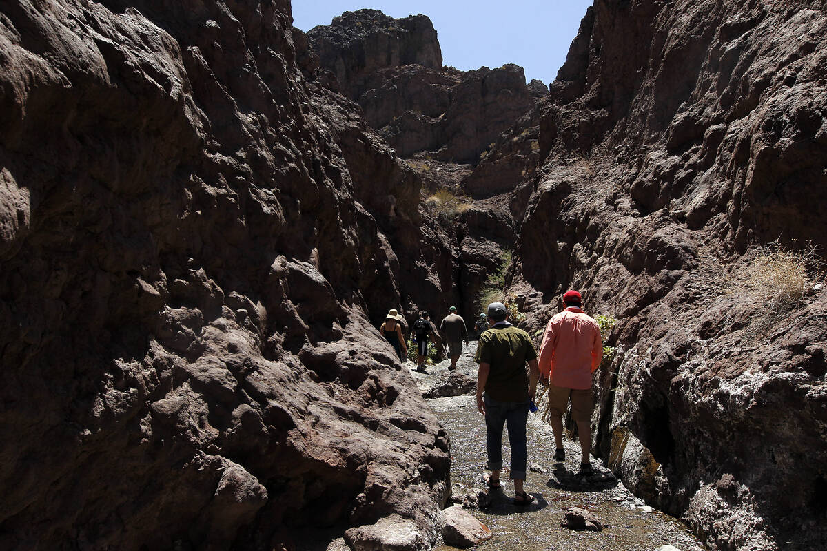 Hikers make their way up a slot canyon just above Arizona Hot Springs Beach in July 2014. (Las ...