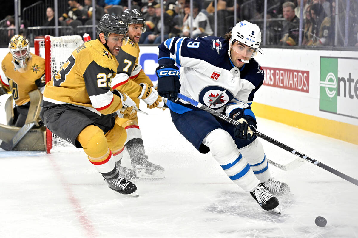 Winnipeg Jets left wing Alex Iafallo (9) handles the puck against Vegas Golden Knights defensem ...