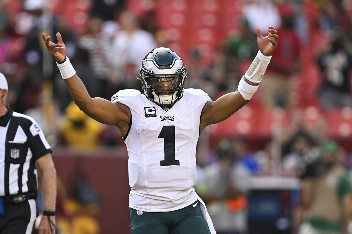 Philadelphia Eagles quarterback Jalen Hurts (1) raises his arms as times expires during the sec ...