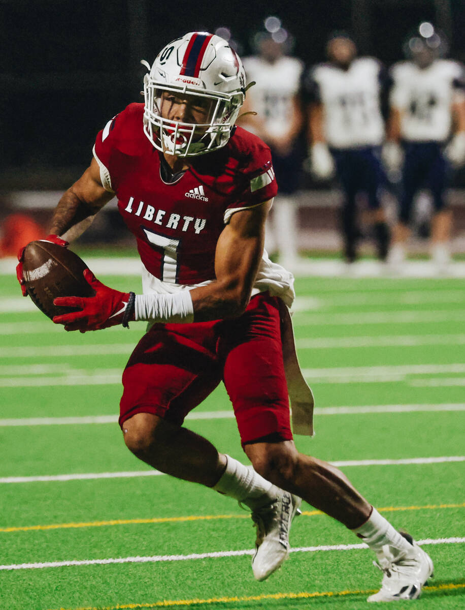 Liberty wide receiver Jayden Robertson runs the ball during a game against Shadow Ridge at Libe ...