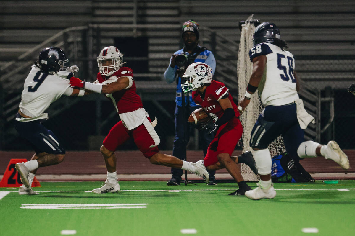 Liberty wide receiver Travis Lopez (9) runs the ball during a game against Shadow Ridge at Libe ...