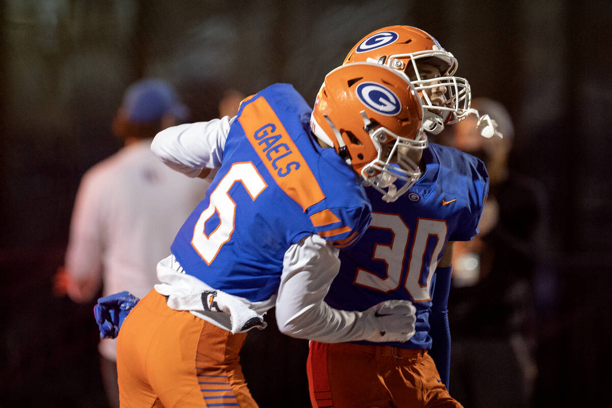 Bishop Gorman wide receivers Brandon Gaea (6) and Derek Meadows (30) celebrate Meadows’ ...