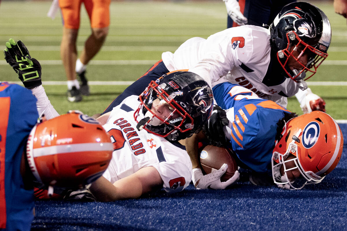 Bishop Gorman running back Micah Kaapana, right, scores a touchdown while Coronado defensive ba ...