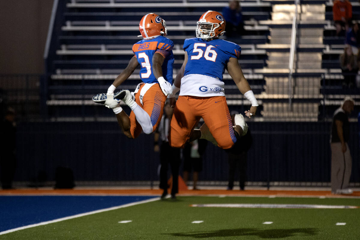 Bishop Gorman running back Devon Rice (3) and offensive lineman Doug Utu (56) celebrate Rice&#x ...