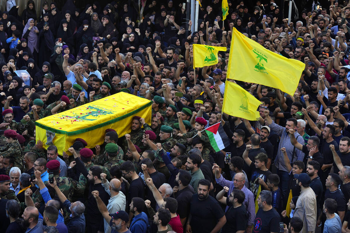 People carry the coffin of Hezbollah fighter, Ali Ibrahim Rmeiti, who was killed by Israeli she ...