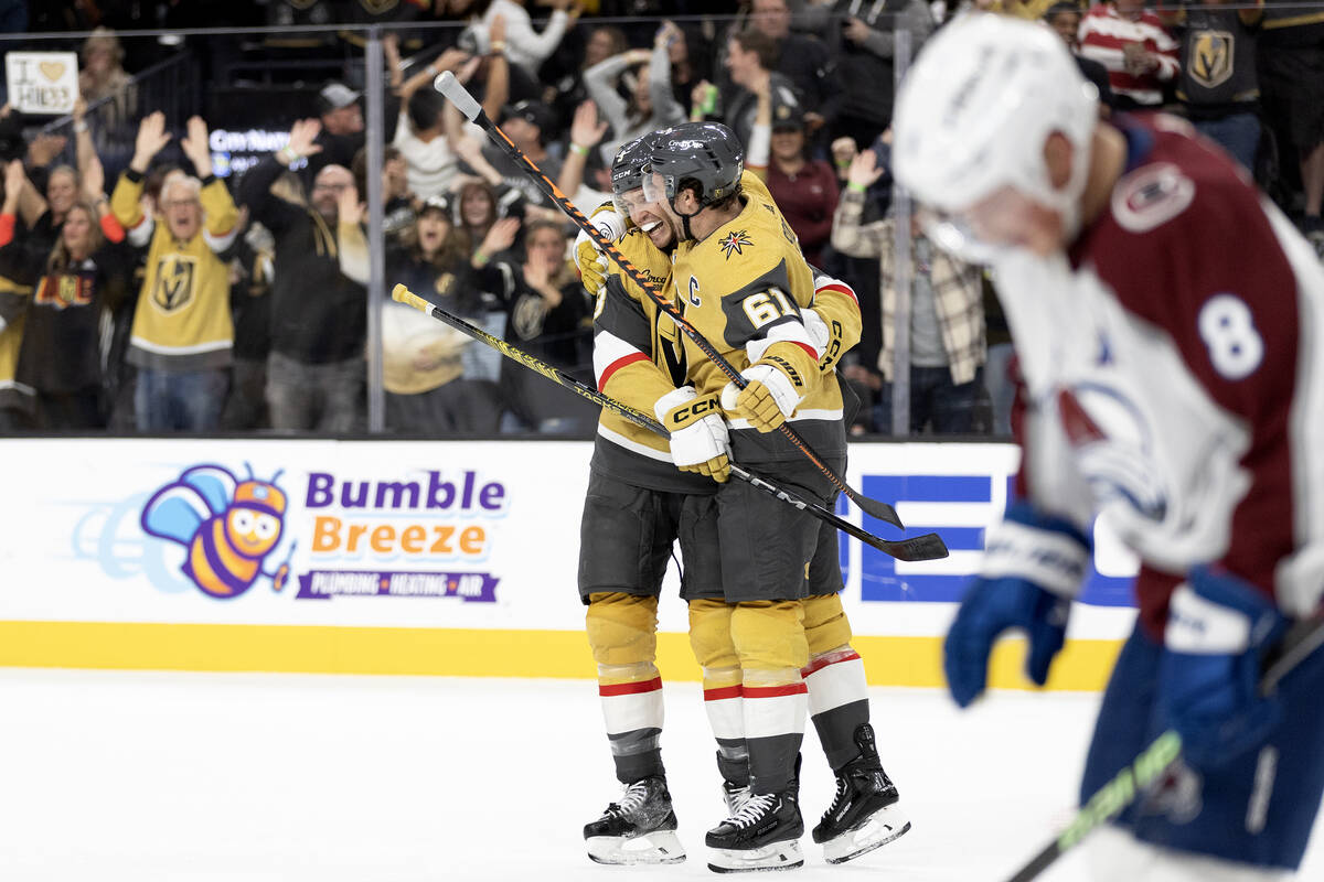 Golden Knights defenseman Brayden McNabb (3) and Golden Knights right wing Mark Stone (61) cele ...