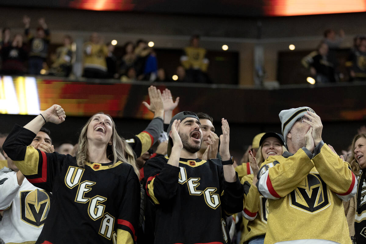 Golden Knights fans celebrate after their team scored during the second period of an NHL hockey ...