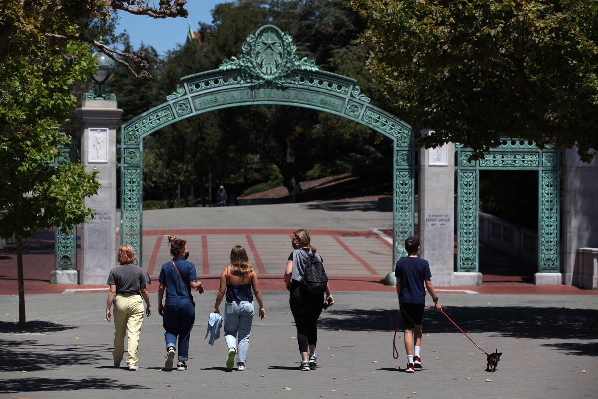 People walk towards Sather Gate on the U.C. Berkeley campus on July 22, 2020, in Berkeley, Cali ...